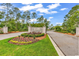 Elegant entrance to the community features beautiful landscaping and a decorative brick sign at 103 Pigeon Forge Ct., Murrells Inlet, SC 29576