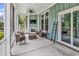 Cozy screened porch with a fireplace and TV offers a relaxing outdoor entertainment area at 103 Pigeon Forge Ct., Murrells Inlet, SC 29576
