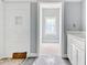 Bathroom featuring tiled walls, framed doorway, and a vanity with a white countertop, designed for comfort at 105 Michau Rd., Georgetown, SC 29440
