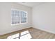 Bedroom with wood-look floors, a large window, and white walls offer a bright and clean aesthetic at 1079 Laconic Dr., Myrtle Beach, SC 29588
