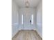 Bright foyer with a modern chandelier, white trim, and wood-look flooring create an inviting entrance at 1079 Laconic Dr., Myrtle Beach, SC 29588