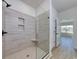 Glass-enclosed shower with tile surround and built-in shower bench at 1079 Laconic Dr., Myrtle Beach, SC 29588