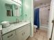 Bathroom featuring a modern vanity with marble countertop, decorative mirror, and tile flooring and tub at 108 Westhill Circle # 7-E, Myrtle Beach, SC 29572