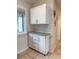 Bright utility area with white cabinets, granite countertop, and tile floors at 108 Westhill Circle # 7-E, Myrtle Beach, SC 29572
