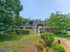 Inviting exterior view of townhouse with lush landscaping, greenery, and a quaint entrance at 108 Westhill Circle # 7-E, Myrtle Beach, SC 29572