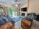 Coastal-themed living room featuring a fireplace, sofas, and access to the outdoor balcony at 108 Westhill Circle # 7-E, Myrtle Beach, SC 29572