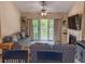 Comfortable living room with fireplace, TV, furniture, and sliding door access to the outside deck at 108 Westhill Circle # 7-E, Myrtle Beach, SC 29572