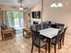Spacious living area with tile floors, dining set, furniture, fireplace, and sliding doors to outdoor deck at 108 Westhill Circle # 7-E, Myrtle Beach, SC 29572