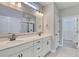 Bathroom featuring double sinks, a vanity with black hardware, and glass enclosed shower at 1083 Laconic Dr., Myrtle Beach, SC 29588