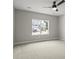 Bedroom features neutral carpeting, a ceiling fan, and a large window at 1083 Laconic Dr., Myrtle Beach, SC 29588