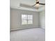 Bedroom with tray ceiling, neutral carpeting, and a window overlooking the neighborhood at 1083 Laconic Dr., Myrtle Beach, SC 29588