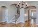 Entryway with wood staircase, chandelier, light gray walls, and hardwood floors at 1083 Laconic Dr., Myrtle Beach, SC 29588