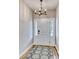 The entryway features a modern chandelier, white door with sidelights, and a stylish black and white rug at 1083 Laconic Dr., Myrtle Beach, SC 29588
