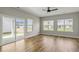 Bright living room with hardwood floors, ceiling fan, and sliding glass doors to the backyard at 1083 Laconic Dr., Myrtle Beach, SC 29588