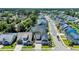 Aerial view of a quiet street with houses with manicured lawns and mature trees at 1145 Captain Hooks Way, North Myrtle Beach, SC 29582