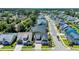 An aerial view shows a neighborhood with similar styled houses and manicured lawns and mature trees at 1145 Captain Hooks Way, North Myrtle Beach, SC 29582