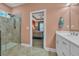 Bathroom with walk-in shower and sink vanity; bedroom visible through the doorway at 1145 Captain Hooks Way, North Myrtle Beach, SC 29582