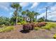 A community sign is shown surrounded by well manicured landscaping and mature palm trees at 1145 Captain Hooks Way, North Myrtle Beach, SC 29582