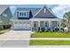 Beautiful home with a two-car garage, and a cozy front porch with white rocking chairs at 1145 Captain Hooks Way, North Myrtle Beach, SC 29582