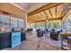 Beautiful outdoor patio with a wooden ceiling, stone floors, nice furniture, and a blue mini-fridge at 1145 Captain Hooks Way, North Myrtle Beach, SC 29582