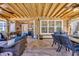 Spacious outdoor patio with beautiful stone flooring, wooden ceiling, a fan, and wicker chairs at 1145 Captain Hooks Way, North Myrtle Beach, SC 29582