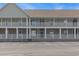 The image shows the exterior of the condo building during daylight hours at 117 Butkus Dr. # 6, Myrtle Beach, SC 29588