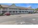 This is an exterior view of the condo building with a parking lot in front of it at 117 Butkus Dr. # 6, Myrtle Beach, SC 29588