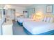 Bright bedroom featuring two queen beds and a view to the kitchen area, with coastal decor at 1207 Ocean Blvd. S # 20802, Myrtle Beach, SC 29577