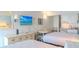 Comfortable bedroom featuring two beds, a small dining table, and a kitchenette at 1207 Ocean Blvd. S # 20802, Myrtle Beach, SC 29577
