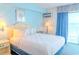 Bright bedroom featuring a queen bed, ocean view, and coastal decor for a relaxing retreat at 1207 Ocean Blvd. S # 20802, Myrtle Beach, SC 29577