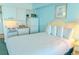 Bright interior of a bedroom with a kitchen area featuring a bed, microwave and refrigerator at 1207 Ocean Blvd. S # 20802, Myrtle Beach, SC 29577