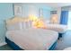 Bright, cozy bedroom featuring two queen beds, soft lighting, and a view of the ocean at 1207 Ocean Blvd. S # 20802, Myrtle Beach, SC 29577