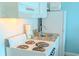 Functional kitchenette equipped with stovetop, microwave, sink, and refrigerator at 1207 Ocean Blvd. S # 20802, Myrtle Beach, SC 29577