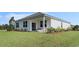 Spacious backyard featuring a covered patio and lush landscaping, offering a serene outdoor space at 128 Dagger Ct., Myrtle Beach, SC 29588