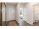 Bright hallway with access to a bathroom and bedroom featuring wood-look floors and neutral paint at 128 Dagger Ct., Myrtle Beach, SC 29588