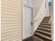 Exterior staircase leading to a private entrance, showcasing the building's access design and siding at 1298 River Oaks Dr. # 5-I, Myrtle Beach, SC 29579