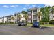 Attractive condo complex with manicured landscaping, palm trees, and convenient parking in a great location at 1298 River Oaks Dr. # 5-I, Myrtle Beach, SC 29579