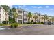 Exterior view of a multi-unit condo complex showcasing well-manicured landscaping and accessible parking spaces at 1298 River Oaks Dr. # 5-I, Myrtle Beach, SC 29579