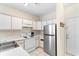 Efficient kitchen with white cabinetry and stainless steel refrigerator, offering practical cooking space and storage at 1298 River Oaks Dr. # 5-I, Myrtle Beach, SC 29579