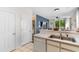Functional kitchen features stainless steel sink and flows into the living area with neutral color palette at 1298 River Oaks Dr. # 5-I, Myrtle Beach, SC 29579