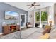 Living room offering a TV, console, couch, balcony access, and a peek into the bedroom at 1298 River Oaks Dr. # 5-I, Myrtle Beach, SC 29579