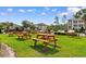 Lush green picnic area featuring wooden picnic tables, perfect for outdoor gatherings and relaxation at 1298 River Oaks Dr. # 5-I, Myrtle Beach, SC 29579
