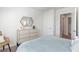 This is a clean bedroom with neutral tones, a dresser, and a geometric mirror hanging above it at 136 Dagger Ct., Myrtle Beach, SC 29588