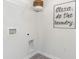 The laundry area has laundry machine hook-ups, storage shelves, and a funny sign at 136 Dagger Ct., Myrtle Beach, SC 29588