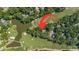 Aerial view of a home on a golf course featuring a pond and lush greenery at 159-1 Weehawka Way # 159-1, Pawleys Island, SC 29585