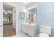 En-suite bathroom with vanity and sink featuring bright blue walls and white tiled floor at 159-1 Weehawka Way # 159-1, Pawleys Island, SC 29585