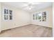 Bedroom featuring neutral carpet, a ceiling fan, and many windows with views at 159-1 Weehawka Way # 159-1, Pawleys Island, SC 29585