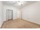 A spacious bedroom has carpet and an open closet with white trim and a ceiling fan at 159-1 Weehawka Way # 159-1, Pawleys Island, SC 29585