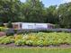 Entrance to community with lush landscaping and colorful flowers at 159-1 Weehawka Way # 159-1, Pawleys Island, SC 29585