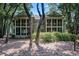 Rear exterior view of a home surrounded by mature trees and landscaping at 159-1 Weehawka Way # 159-1, Pawleys Island, SC 29585